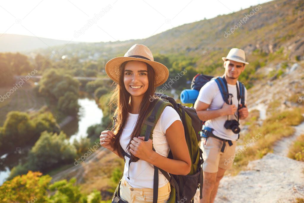 Couple hikers with backpack on hike in nature