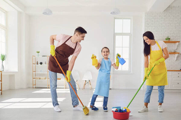 Happy family cleans the room in the house.