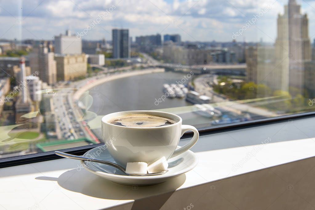 coffee Cup on windowsill with city view