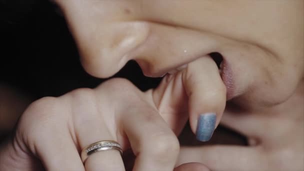 Extreme close up of woman biting her finger because of pain — Stock Video