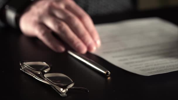 Крупним планом знімок рук чоловіка, який підписує документи, вибірковий фокус . — стокове відео