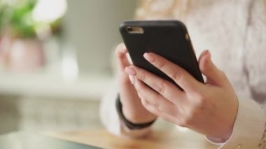 Yakın çekim genç bir kızın, bir smartphone tutan eller.