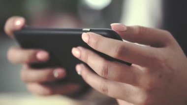 Bir cep telefonu tutan bir kız parmak bir makro çekim.