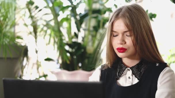 Joven mujer de negocios buscando noticias de stock en Internet en una computadora portátil — Vídeo de stock