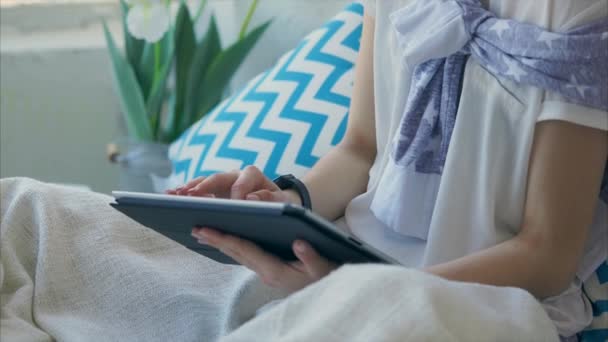 Close up shot of female hands who uses a gadget for the university at home — Stock Video