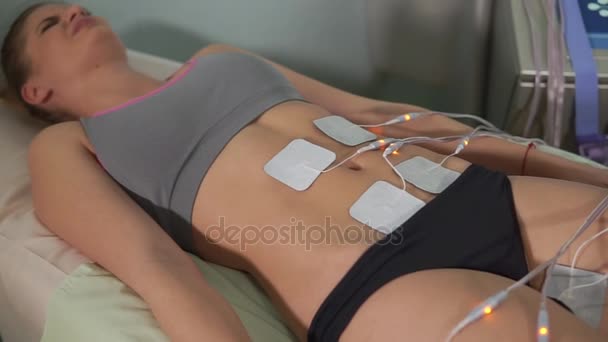 Woman patient getting electro stimulation. Hardware cosmetology. — Stock Video