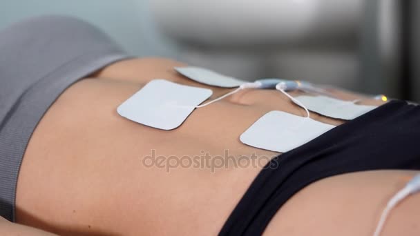 Procedimiento antiedad. Paciente femenina recibiendo electroestimulación de barriga . — Vídeo de stock
