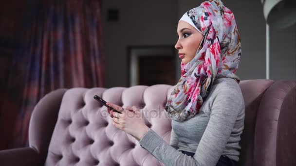 Femme musulmane en hijab surfer sur Internet sur mobile à la maison — Video