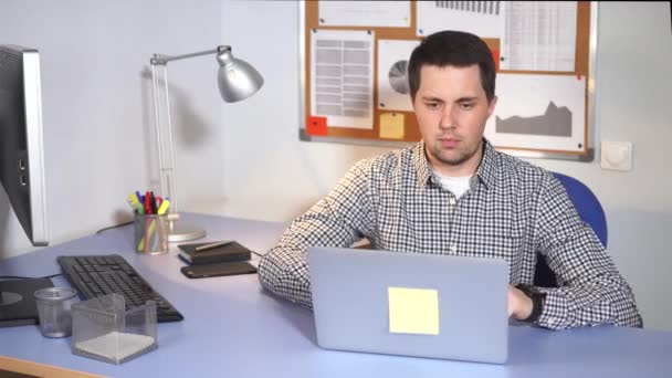 Trabajador de oficina usando laptop. Hombre caucásico en ropa casual usando portátil . — Vídeo de stock