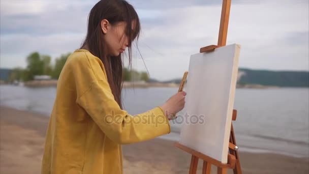 Творча жінка художник готує полотно з великим пензлем і рішенням — стокове відео