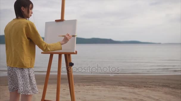 Artista femenina preparando lienzo para pintar en la orilla del río . — Vídeos de Stock