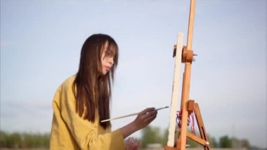 Göl kenarında yağlı boya ile resim çizim kadın ressam