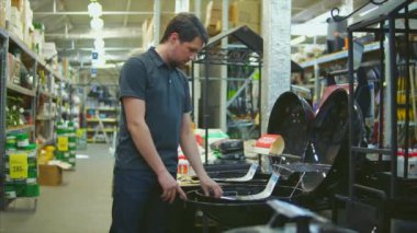 Izgara da ülke evi için seçtiğiniz alışveriş merkezinde genç adam.