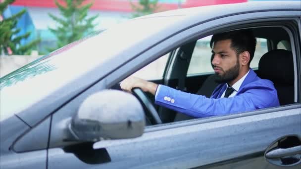Homem de fato a conduzir o carro. Homem muçulmano com rosto sério dirigindo carro à esquerda . — Vídeo de Stock