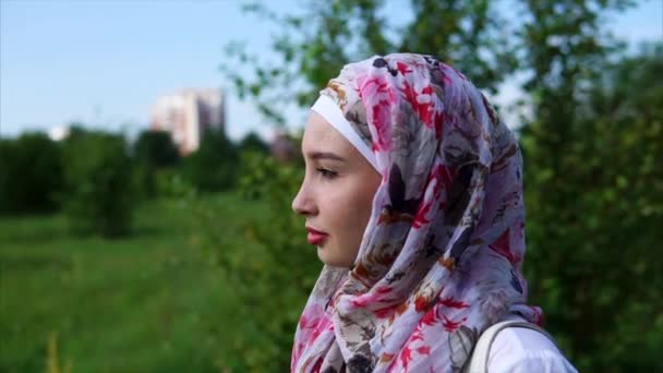 Egy fiatal muszlim nő visel a hidzsáb, aki élvezi a magányt parkban portréja — Stock videók