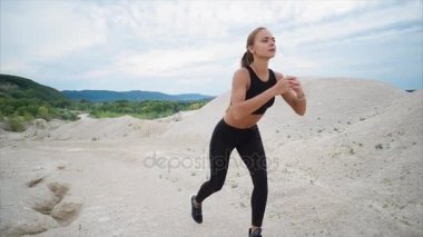 Onun bacak kaslarını güçlendirmek için genç bir atlet crouches, o doğada