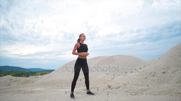 Chica haciendo sentadillas ejercicio durante el entrenamiento fuera de la ciudad — Vídeos de Stock