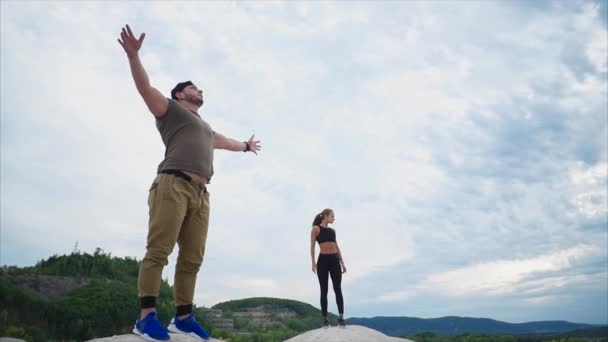 Fitness instructors stand on a low mountain and enjoy a beautiful view — Stock Video