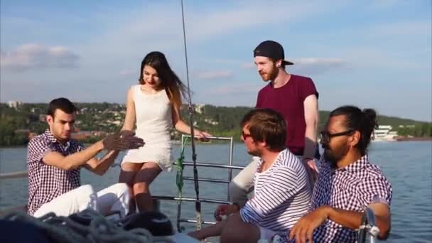 Un jeune homme qui monte sur un yacht crie à ses amis une histoire drôle — Video