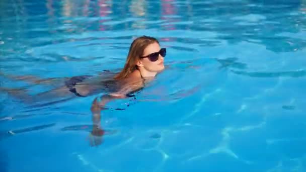 La mujer está nadando en la piscina sola . — Vídeos de Stock