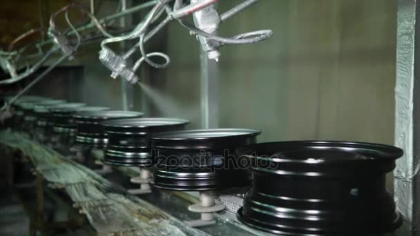 Robotic målning maskiner sprutning metalliska färger över stålfälgar. — Stockvideo