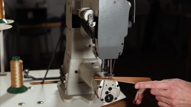 Craftworker sewing leather on machine — Stock Video