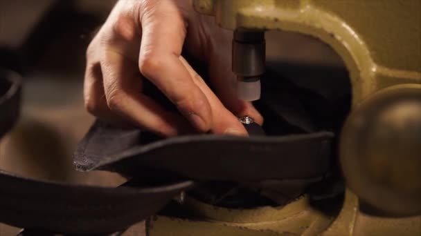 Tailor is compressing rivet on leather bag by a hand press for metal fittings — Stock Video