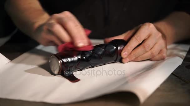 Man is cleaning leather item in workshop. — Stock Video