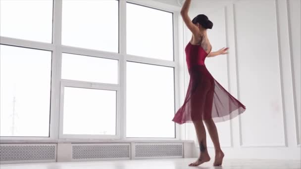 Een jonge dame dansen, een vrouw elegant verhoogt haar armen omhoog tijdens bewegingen — Stockvideo