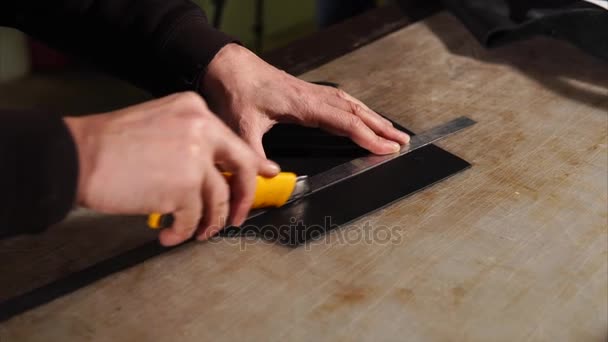 Close up shot of mans hands, who cuts off unnecessary pieces of material — Stock Video