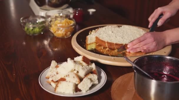 Chefs hand, who prepares a dessert on the table, where there is a cake, fruit — Stock Video