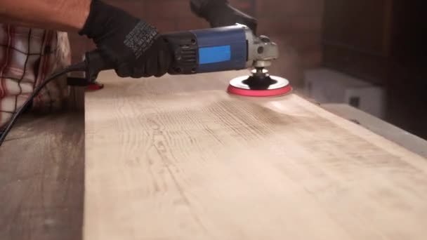 Крупным планом снимок руки человека, который шлифует стол с помощью электрической дриллы — стоковое видео