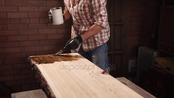 Primer plano de las manos de los carpinteros, el hombre sostiene el frasco de barniz y cepillo — Vídeos de Stock