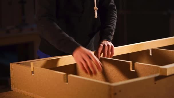 Detailní záběr záběr mans ruce, kteří vloží deska do panelu dřevotřískové desky — Stock video
