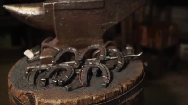 Plenty horseshoes by the anvil — Stock Video