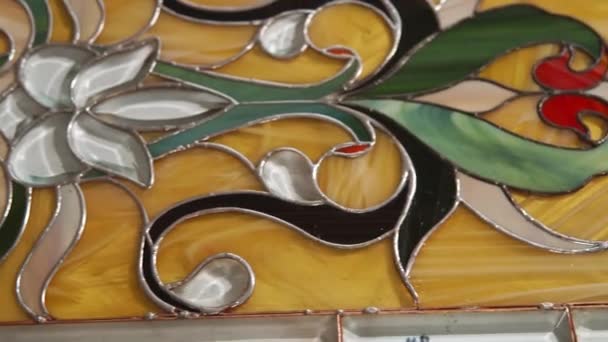 Close up shot of a stained glass window, which is executed in a colored style — Stock Video