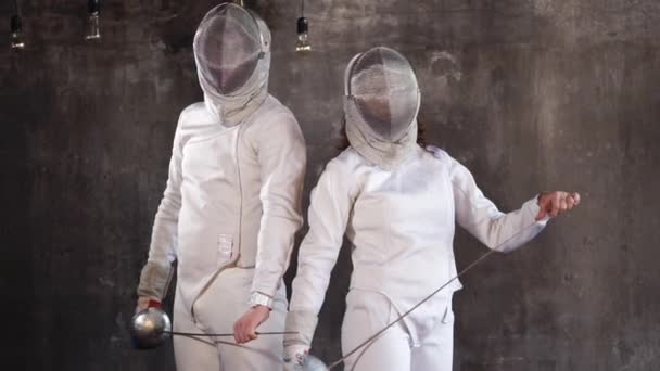 Man and woman holding piercing weapons, athletes engaged in active fencing — Stock Video