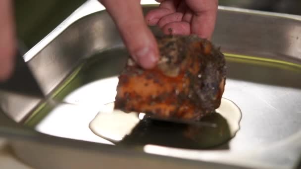 Close up shot of the mens hands, who prepares a roll of trout, he put on plate — Stock Video