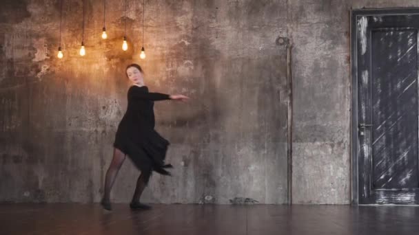 Bailarina entrenada gira en una danza dramática en un salón gótico oscuro — Vídeo de stock