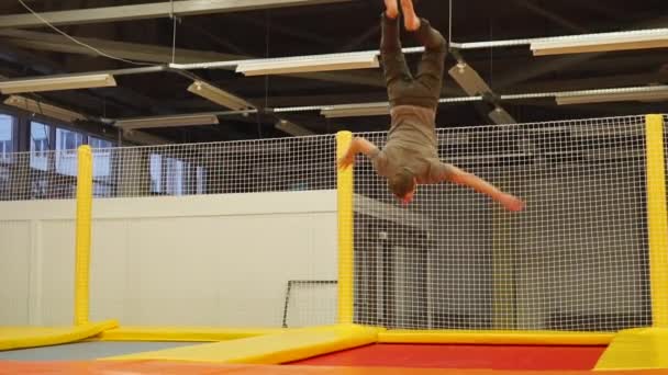 Masculino gimnasta saltando en un trampolín — Vídeo de stock