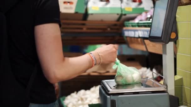 Homme pesant des légumes à l'échelle numérique dans un supermarché — Video