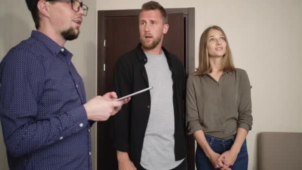 Couple is talking with realtor in rental flat — Stock Video