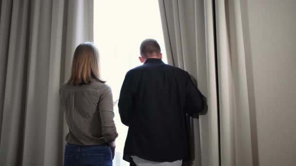 Пара оглядає кімнату квартири — стокове відео