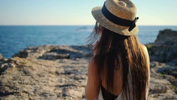 Girl with mobile relaxing on sea coast — 图库视频影像