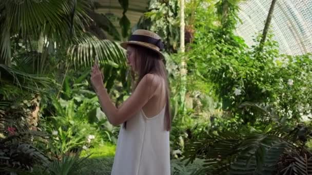 Flicka tar mobila bilder i växthuset i Lednice, Tjeckien — Stockvideo