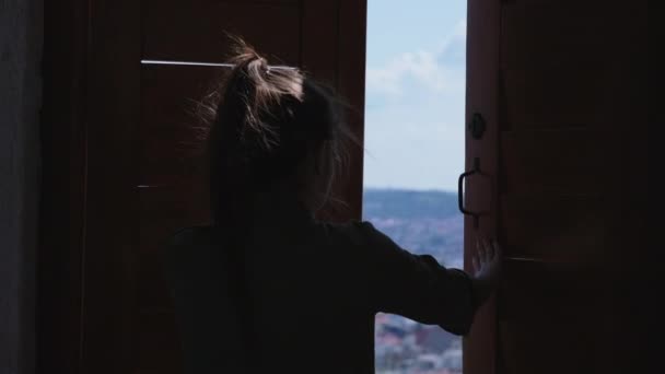 Woman is opening window of observation tower and viewing panorama of Brno — ストック動画