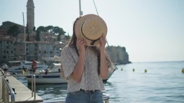 Female tourist is playing with summer hat in Rovinj town in Croatia — Stock Video