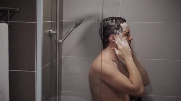 Hombre adulto se lava la cabeza en la ducha — Vídeo de stock