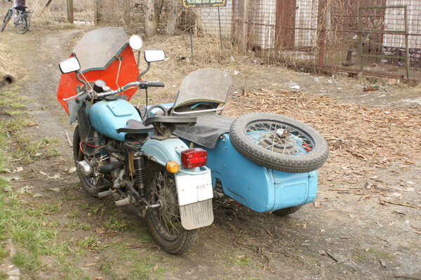 Ural motorcycle stands in a Russian village
