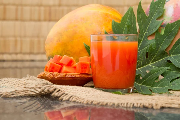 Verse papaya SAP in het glas met papaya, fruit-, blad- en segmenten — Stockfoto